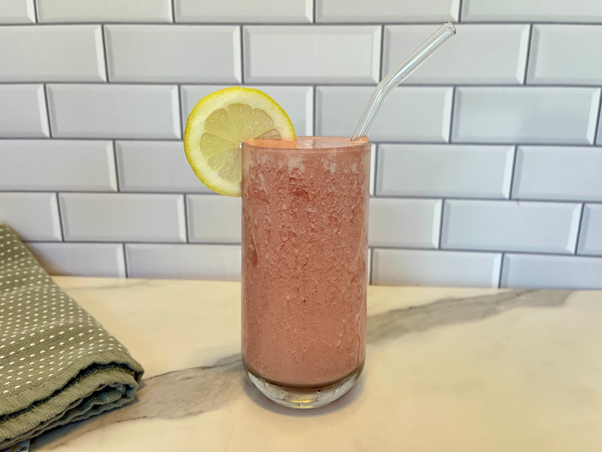 Image of strawberry smoothie in glass with strawa