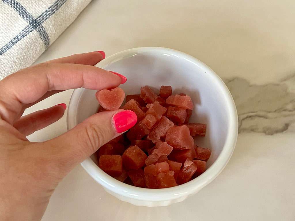 hand holding strawberry gummies